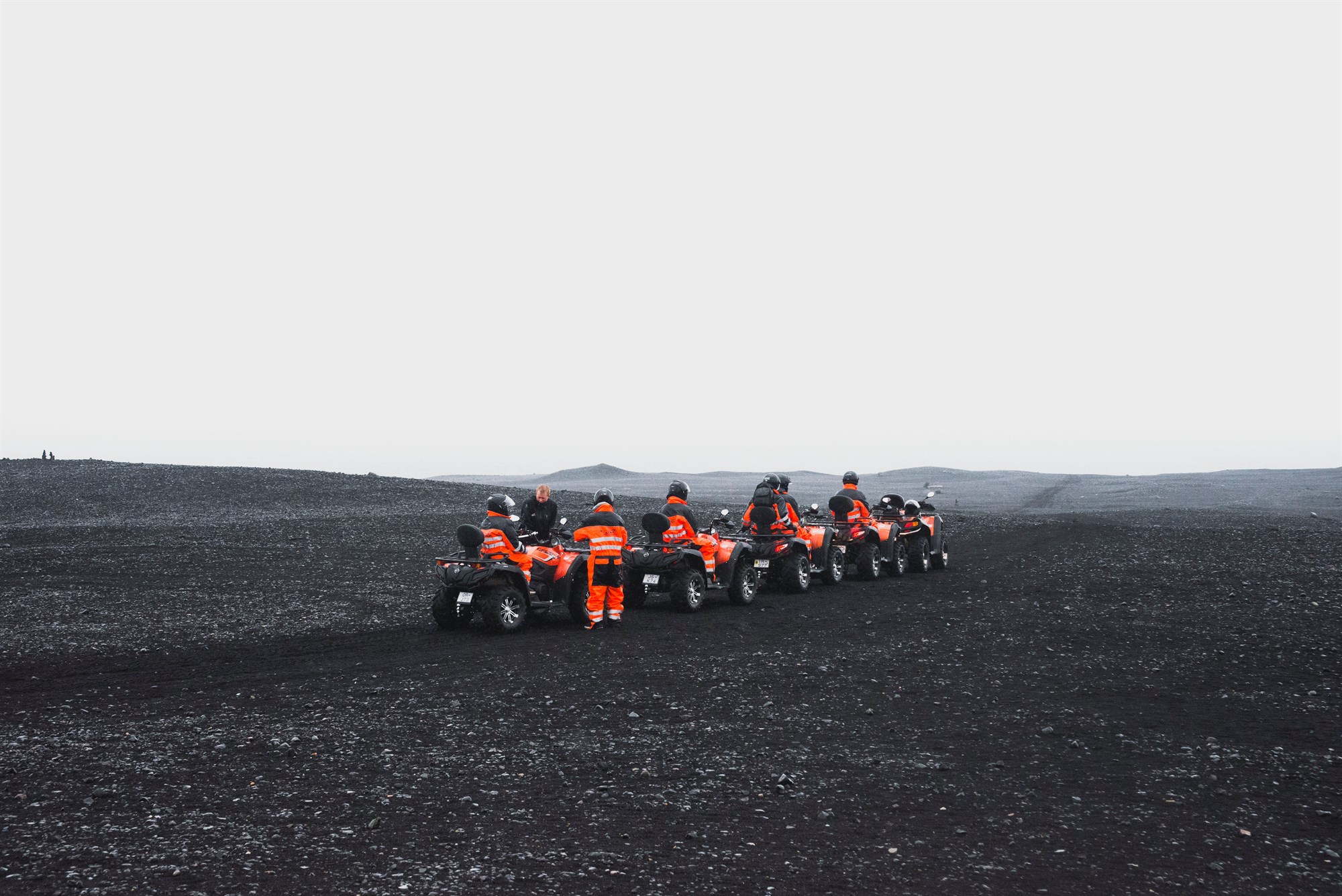 Group of people in bright suits on ATVs in south Iceland.