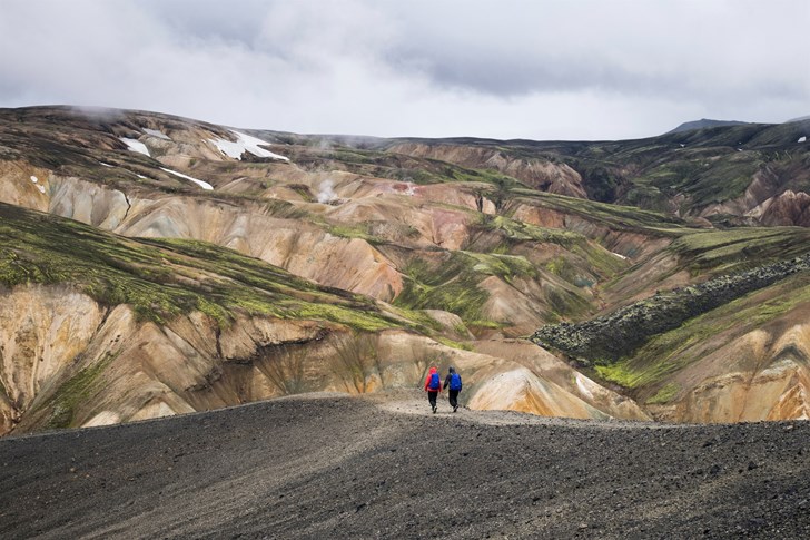 Two people following a path in Iceland's Lannmannalaugur region