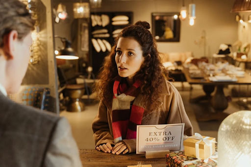 Woman standing at a shop counter in Iceland.