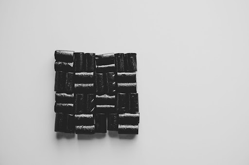 Pieces of black salmiak liquorice arranged into a square