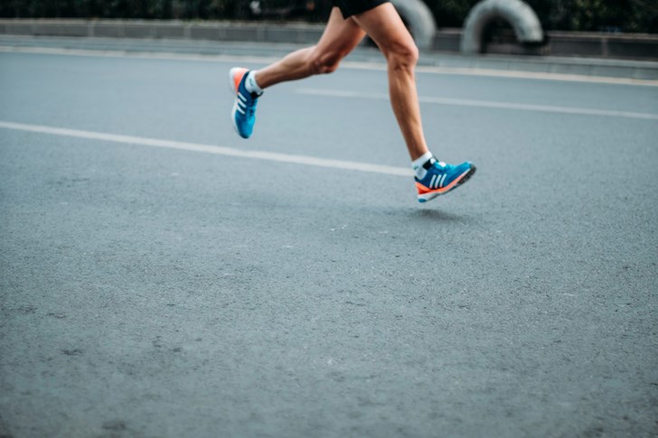 Someone running on tarmac roads of the Iceland Midnight Run.